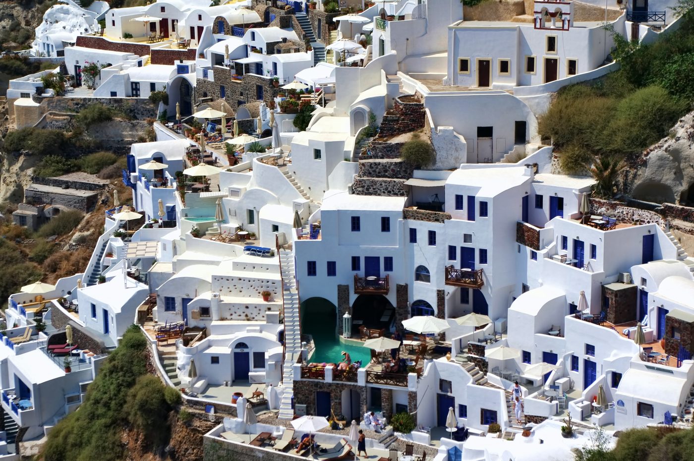 The white-washed village of Oia with its iconic blue-domed churches, Santorini
