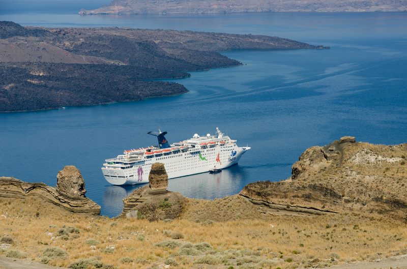 A Grand Celebration cruise ship sailing in the caldera of Santorini, Greece.