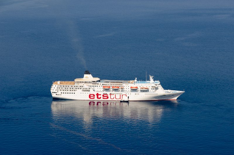 A cruise ship sails through the caldera of Santorini, Greece.