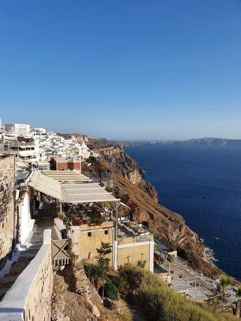The cliffside walking path along the caldera rim, lined with cafe terraces and sea views