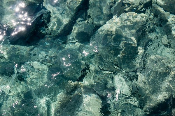 Clear blue water at the coast of Perissa beach, Santorini
